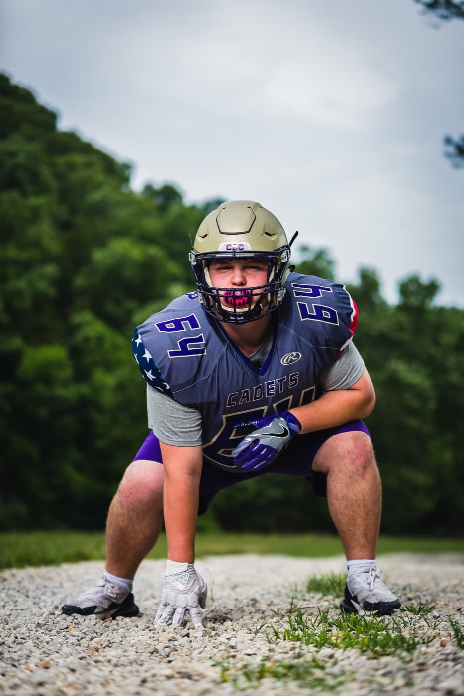 Football player on a gravel path, photographed by Dan Brugere
